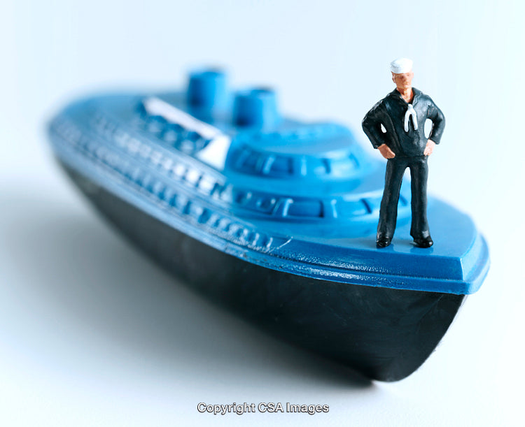 Blue Model Ship with Sailor Figurine on White Background