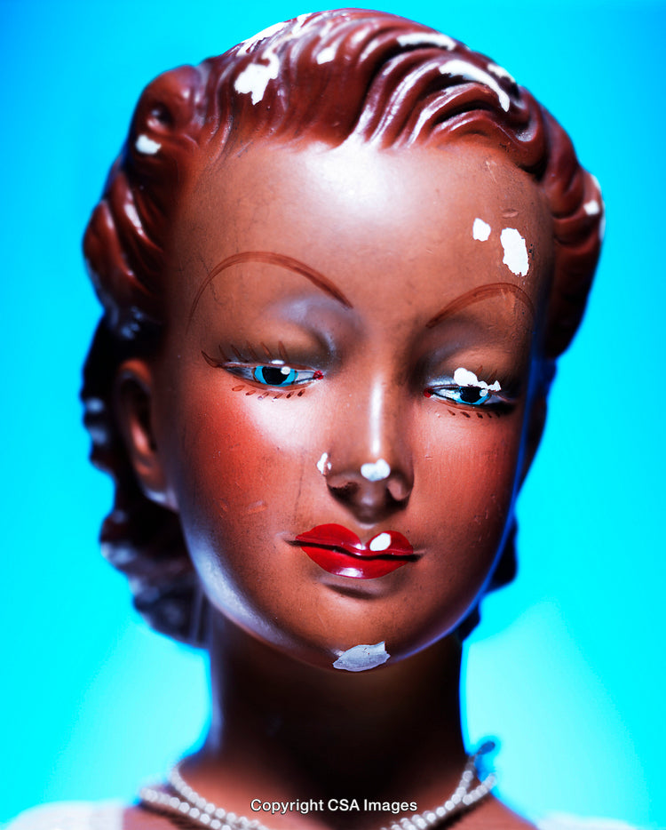 Close-Up of Vintage Doll with Aging Marks and Bright Detailing