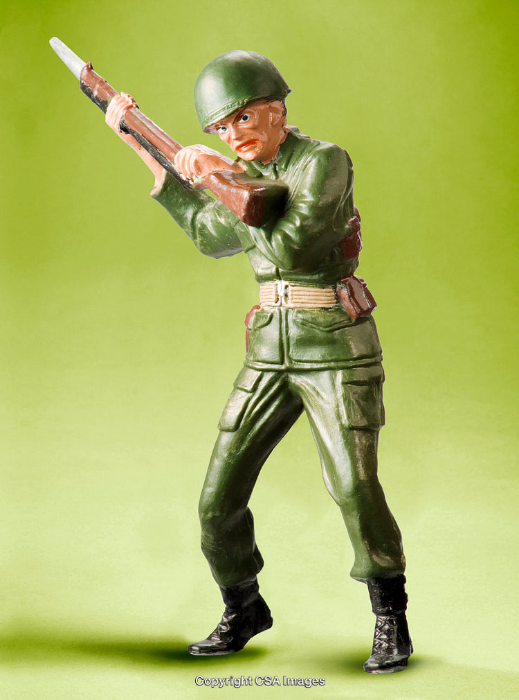 Painted Plastic Soldier Figurine Aiming Rifle Against Soft Green Background