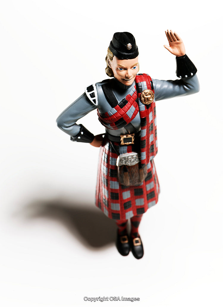 Plastic Toy Figure Depicting Person in Traditional Red Tartan Attire