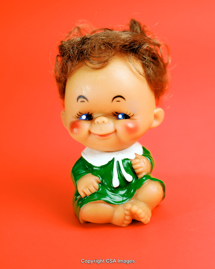 Adorable Retro Plastic Doll on Bright Orange Background
