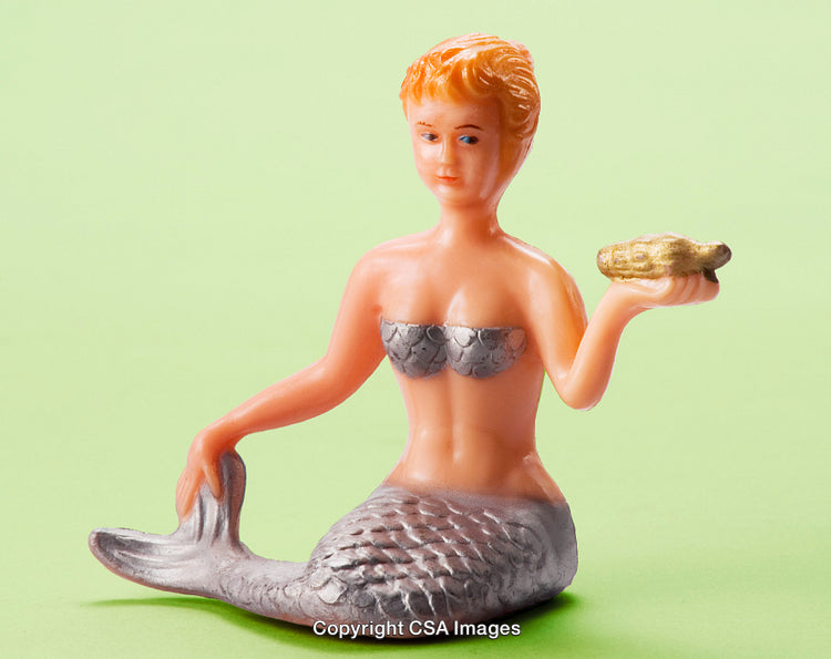 Plastic Mermaid Figurine on Light Green Background Holding Golden Shell