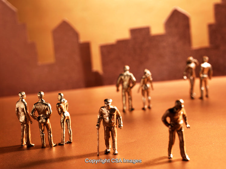 Golden Miniature Figures Posed Against a Cityscape Background