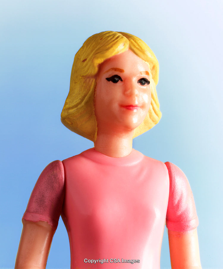 Close-Up of a Plastic Toy Figurine in Pink Dress