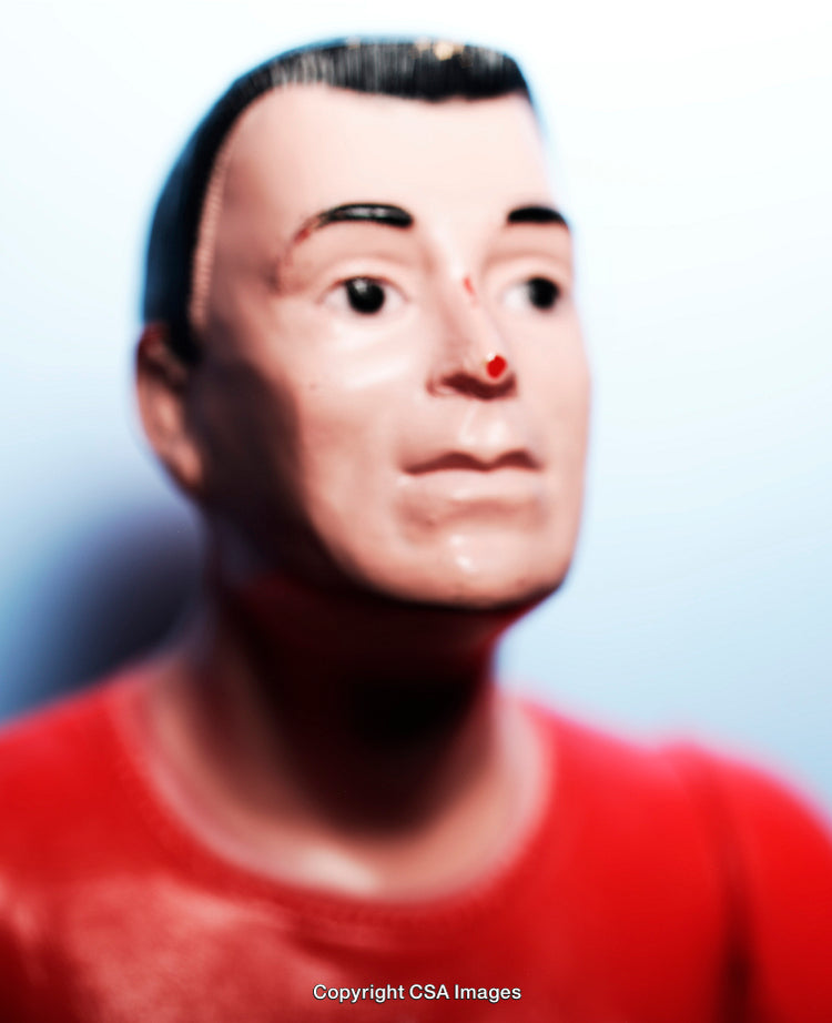 Close-up of a Red-Clad Plastic Figurine with Detailed Face