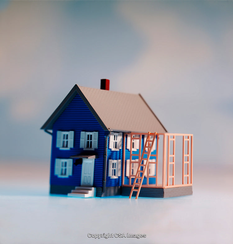 Miniature Blue House Model Undergoing Construction With Ladder