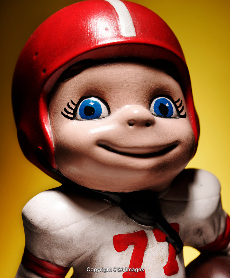 Close-Up of a Smiling Figurine Wearing a Sports Uniform and Helmet