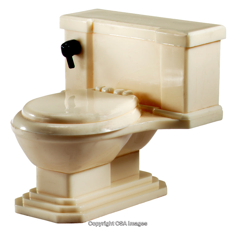 Close-Up of a Vintage Style Plastic Toilet Toy on a White Background