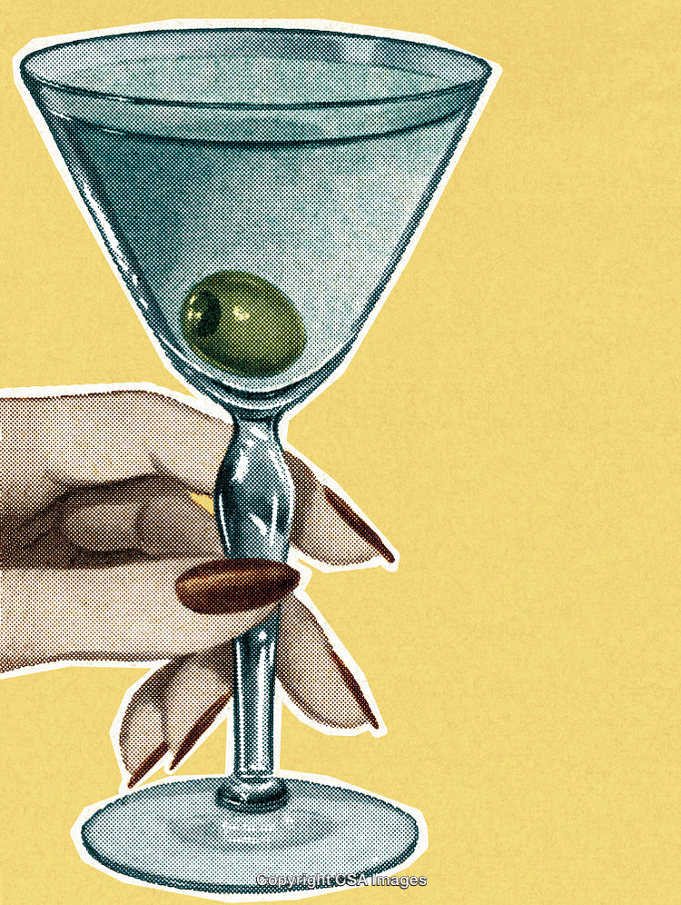Hand Holding Martini Glass with Olive Against Yellow Background