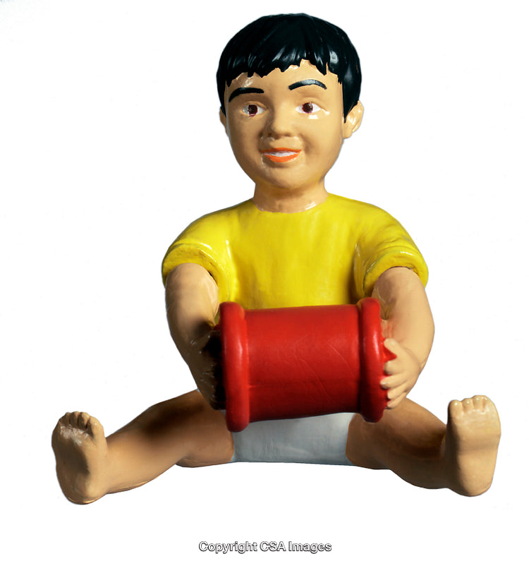 Toy Figure of a Child Sitting with a Red Cylinder in Hands