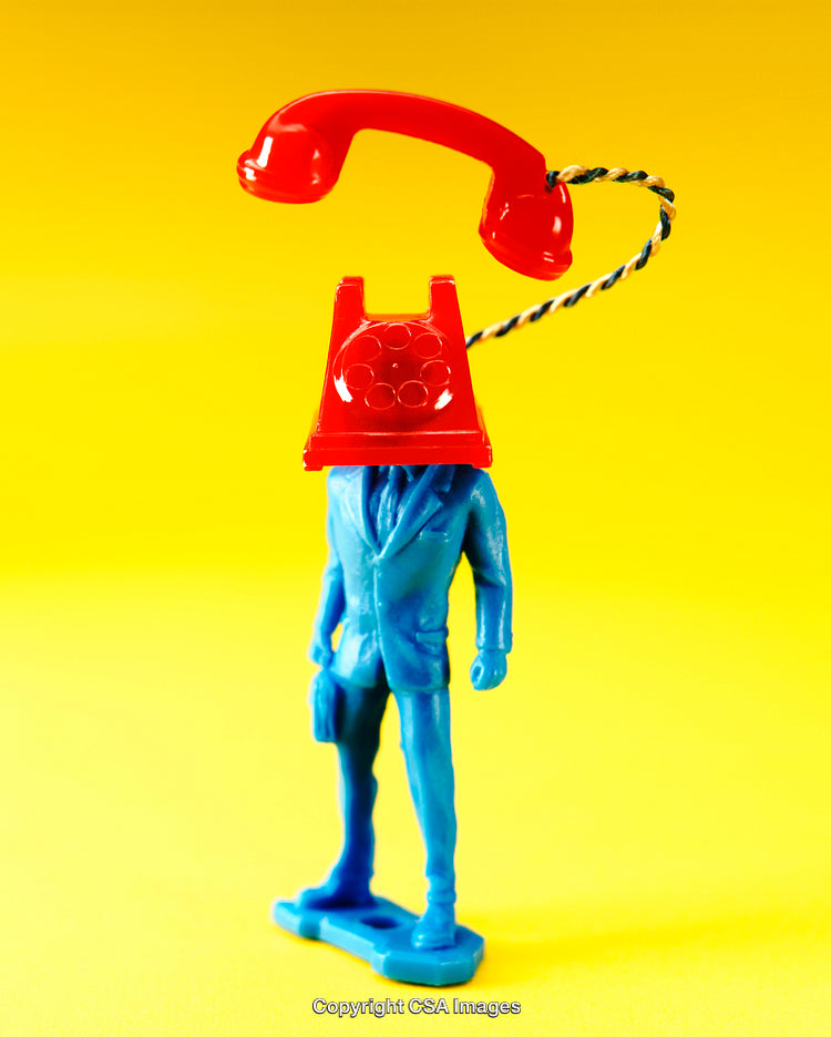 Surreal Plastic Toy Sculpture Depicting a Telephone-Headed Businessman on Yellow Background