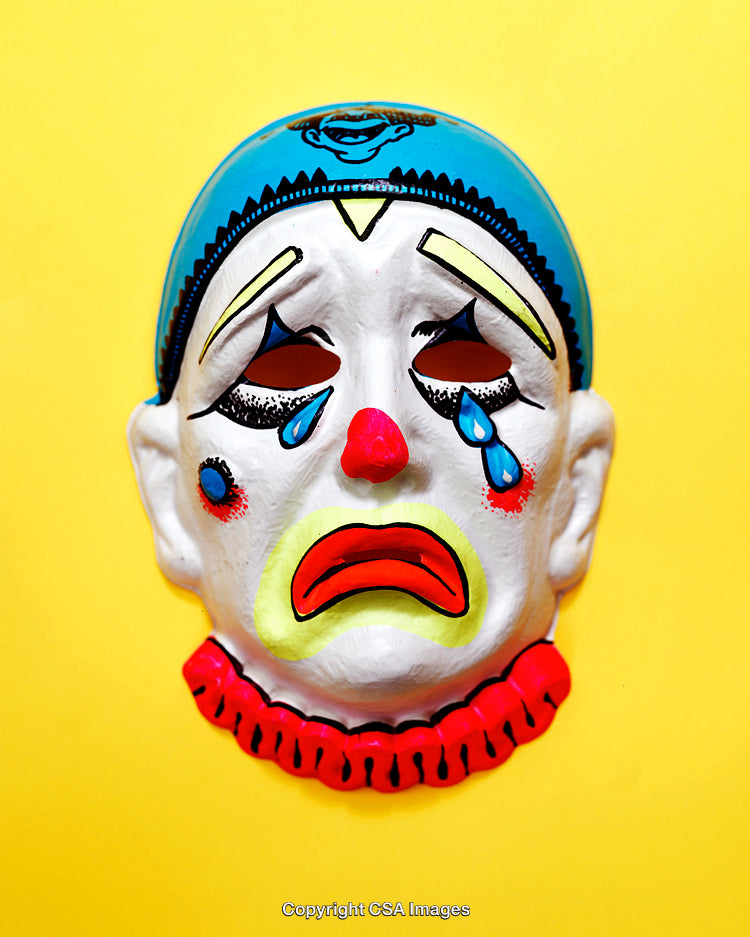 Colorful Sad Clown Mask on Vibrant Yellow Background