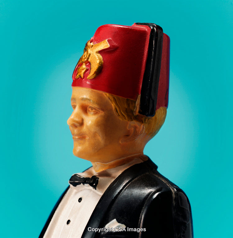 Classic Figurine of a Smiling Man in a Tuxedo and Red Fez Hat