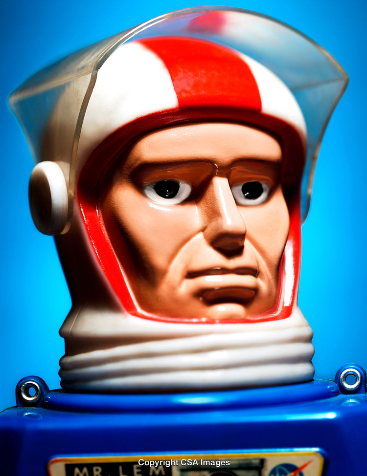 Toy Astronaut Figure With Bright Helmet Against Vibrant Blue Background