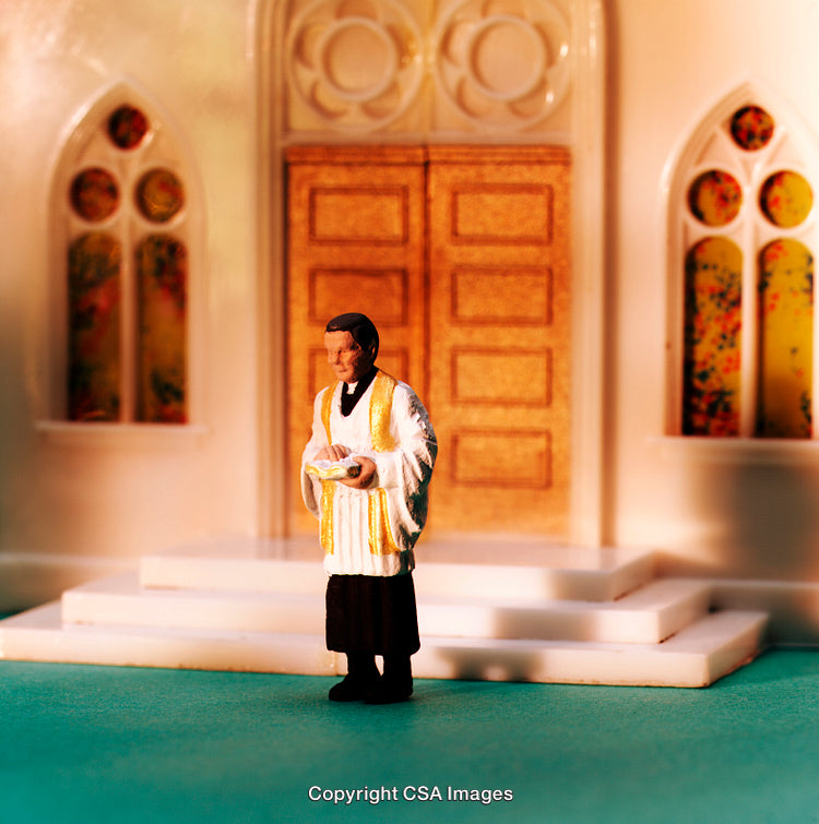 Miniature Priest Figurine Posed Outside Model Church with Detailed Architecture