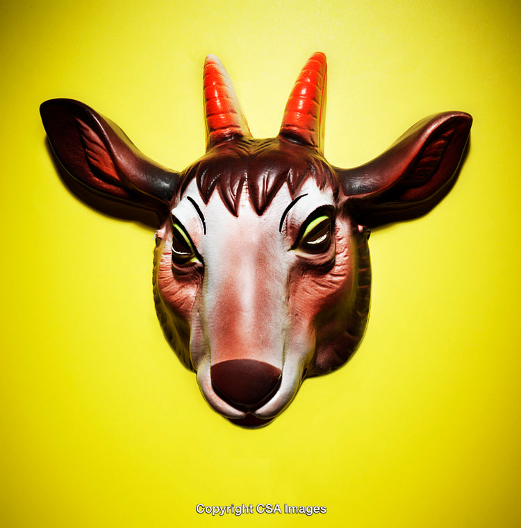 Colorful Plastic Animal Mask on Bright Yellow Background