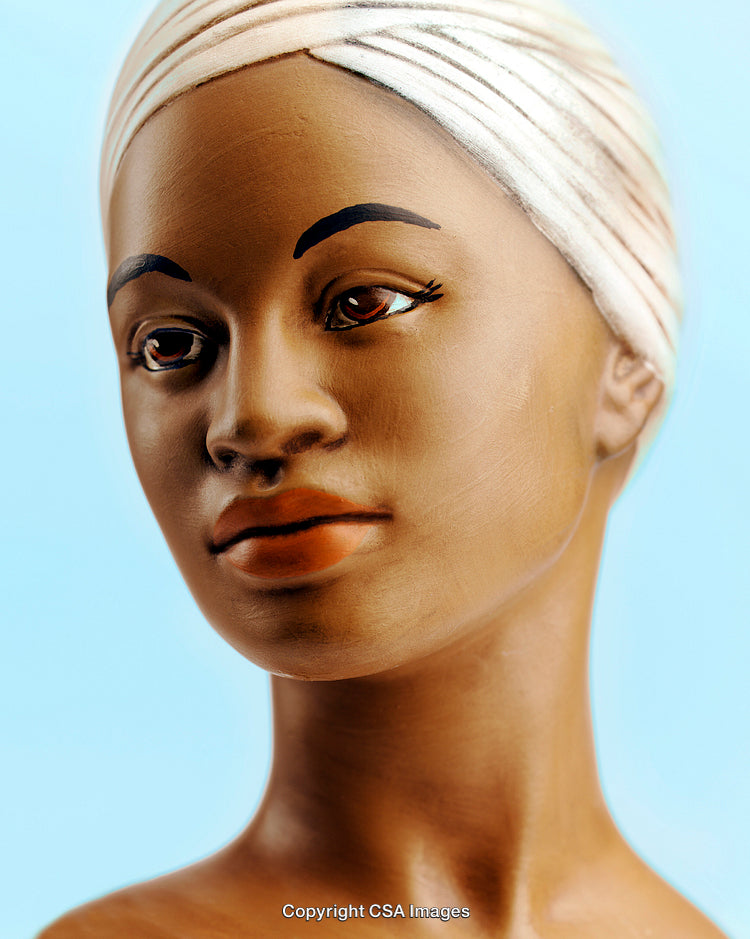 Detailed Close-Up of Artistic Female Figurine with Headscarf on Light Background