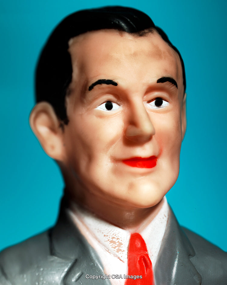 Plastic Figure of a Businessman Character Displayed Against Blue Background