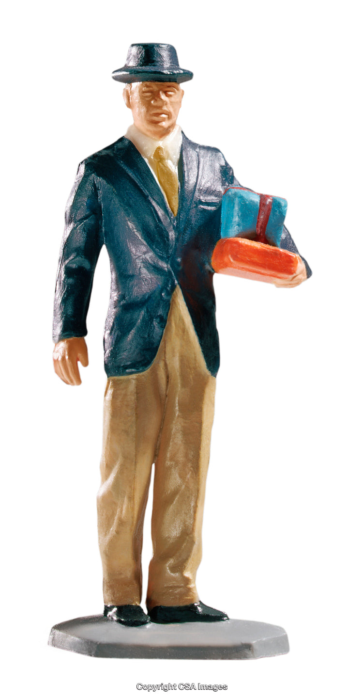 Toy Figure of a Businessman Holding Gifts in Traditional Suit