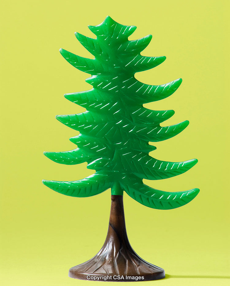 Bright Green Plastic Pine Tree on Yellow Background