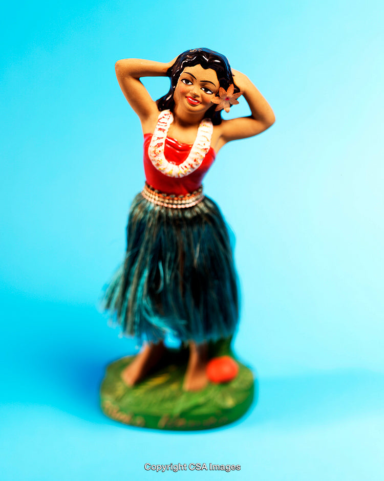Hula Doll Figurine in Traditional Hawaiian Dance Attire on Blue Background
