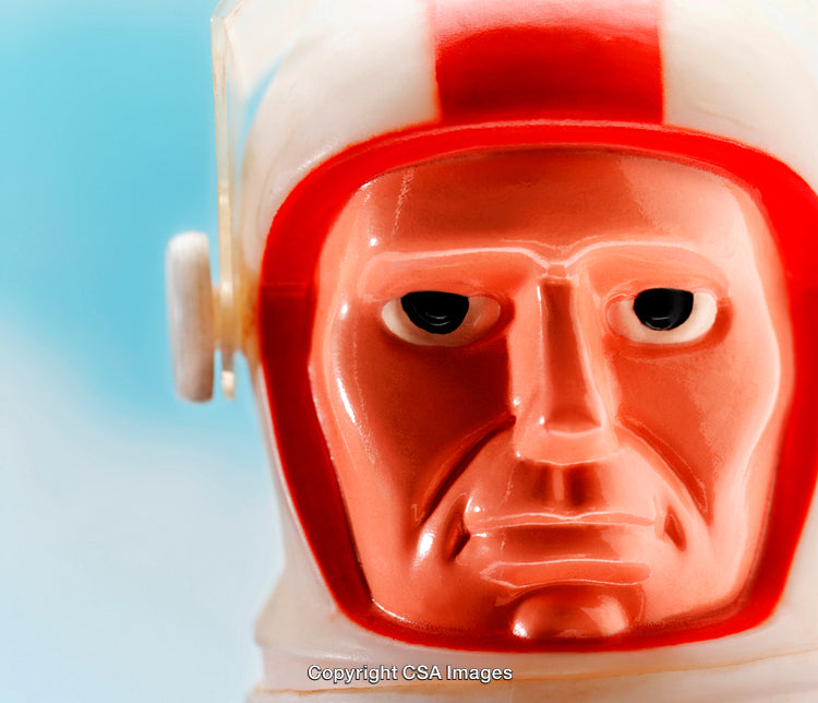 Close-Up of a Vintage Plastic Astronaut Toy Against a Sky Background