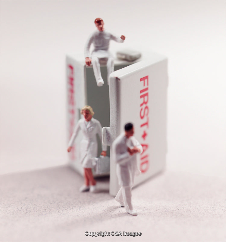 Tiny Medical Figures with First Aid Kit in Artistic Concept