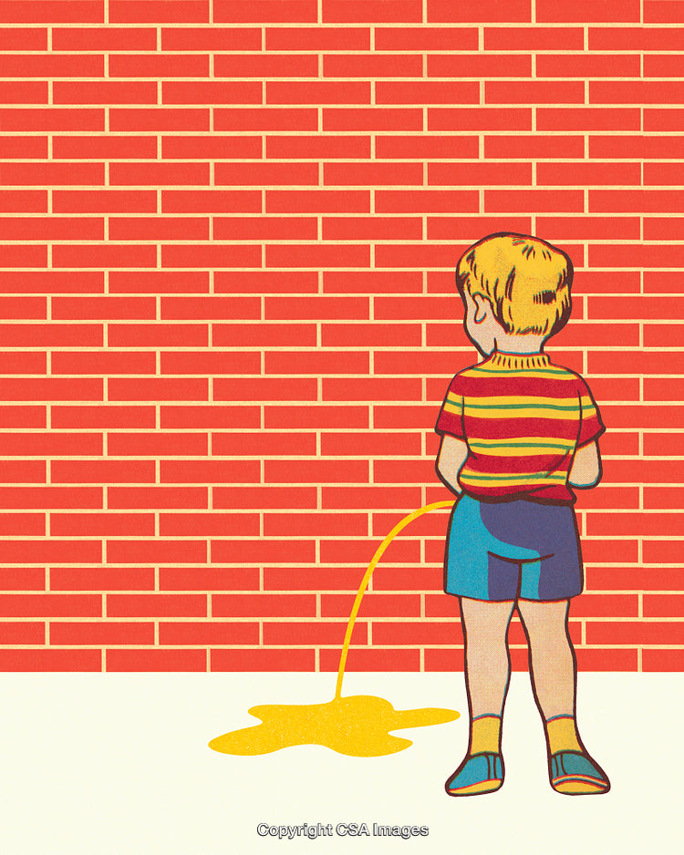 Young Boy in Colorful Outfit Standing Outdoors in Front of a Brick Wall