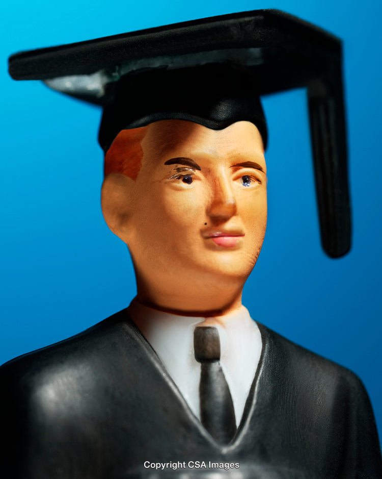 Close-Up of Graduation Toy Figure in Academic Cap and Gown