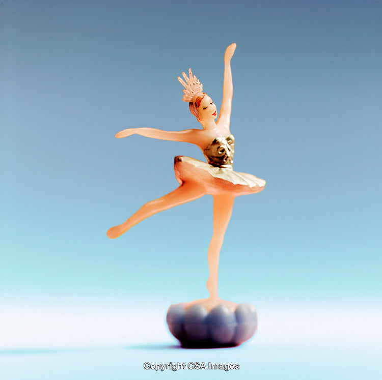 Elegant Plastic Ballerina Figurine Dancing Gracefully on Blue Background