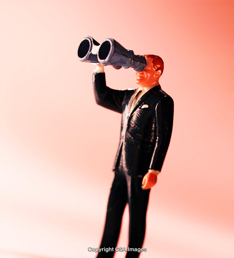 Miniature Figurine Businessman with Binoculars on Pink Background