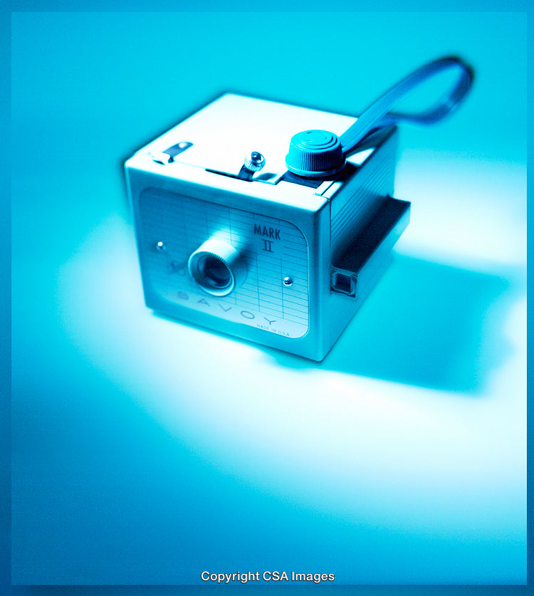 Vintage Blue Camera Object in Artistic Light on a Colored Background