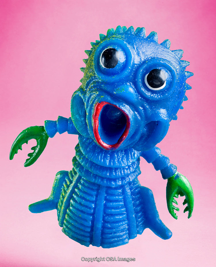 Blue Plastic Creature Toy with Green Claws on Pink Background