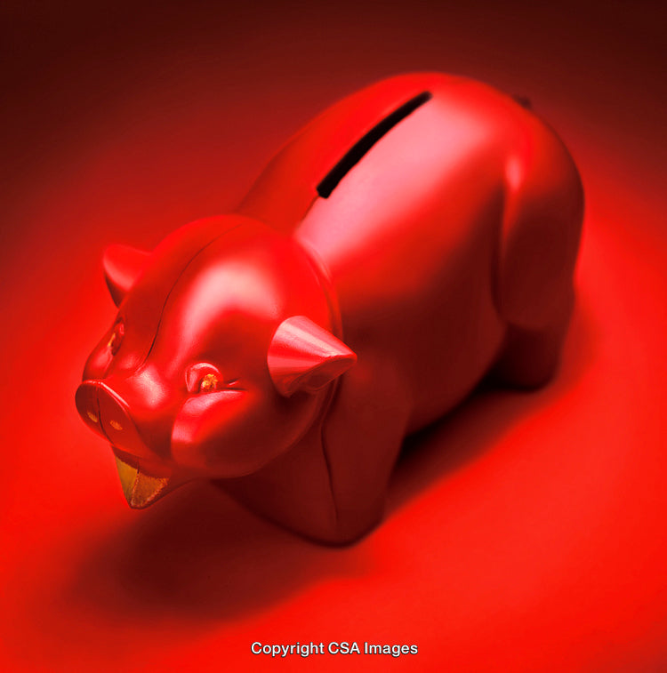 Red Piggy Bank Against a Bright Red Background Reflecting Light