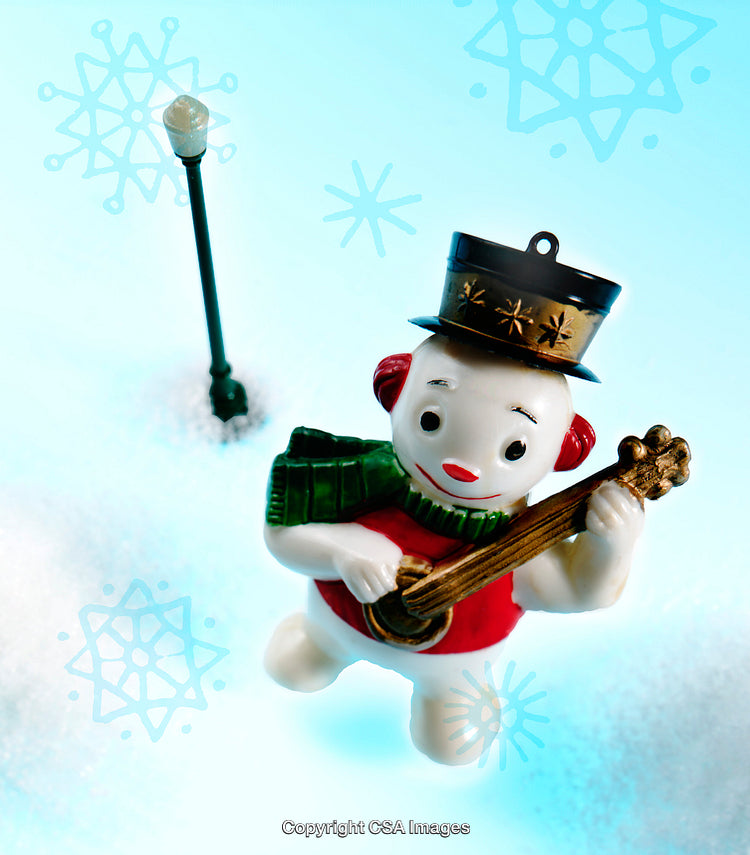 Festive Snowman Figurine Playing Guitar on Snowy Background
