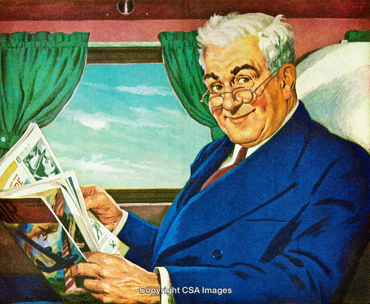 Smiling Senior Man Reading Magazine on Comfortable Train Journey