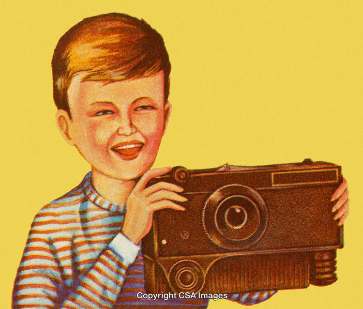 Young Boy Enjoying Photography with a Vintage Camera and Yellow Background