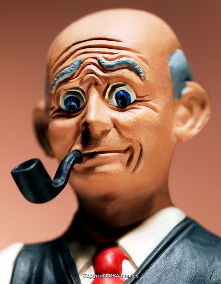 Close-Up of a Cheerful Figurine with a Pipe and Expressive Features