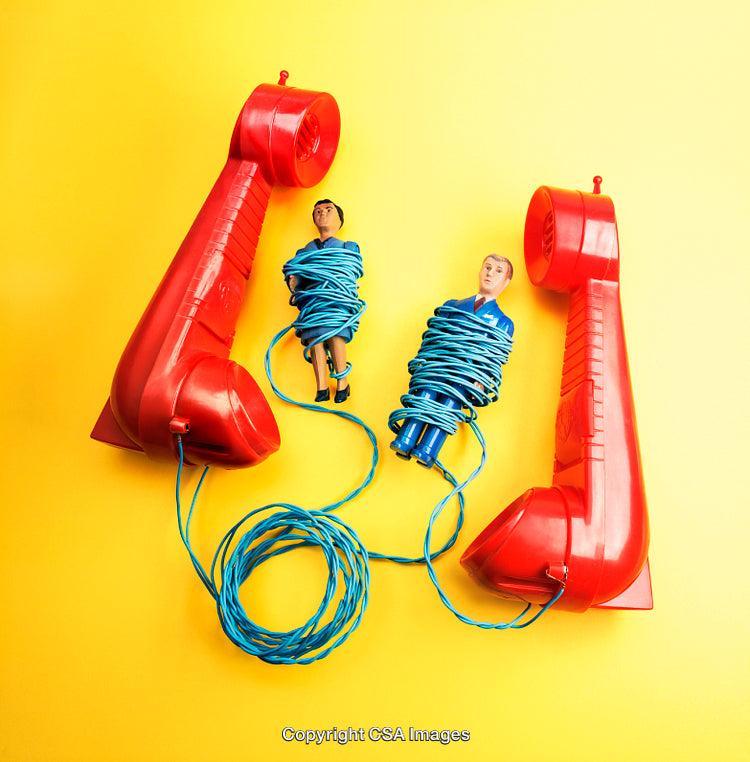 Two Red Handsets and Figures Bound With Blue Wire on Yellow Background