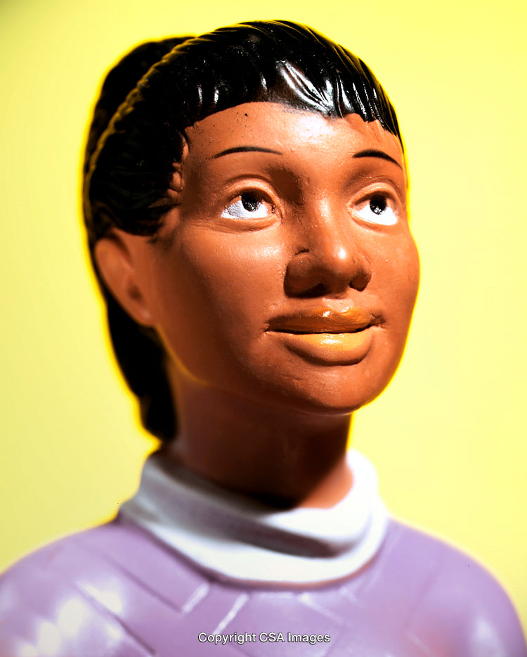 Close-Up of a Plastic Figure Against a Yellow Background