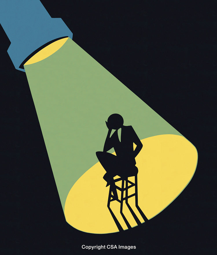 Silhouette of a Thinking Business Person Illuminated Under a Spotlight