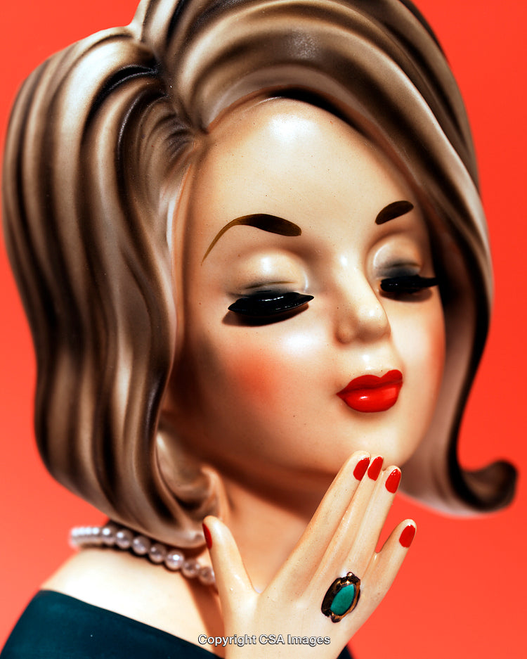 Stylized Figurine of Elegant Woman with Vintage Aesthetic on Red Background