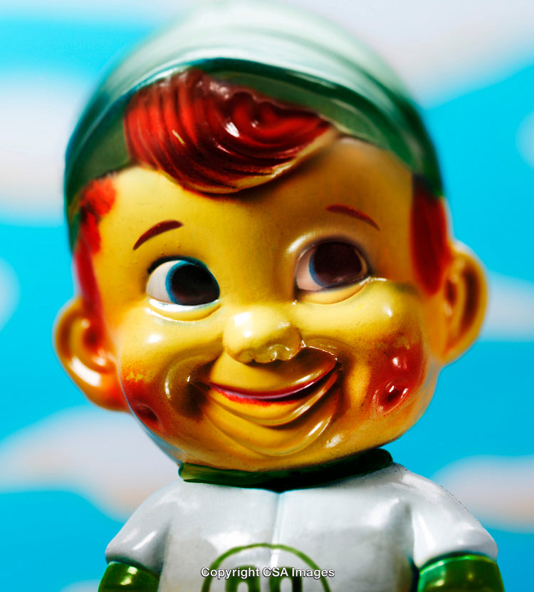 Vintage Plastic Toy Figure With Colorful Design Against a Bright Background