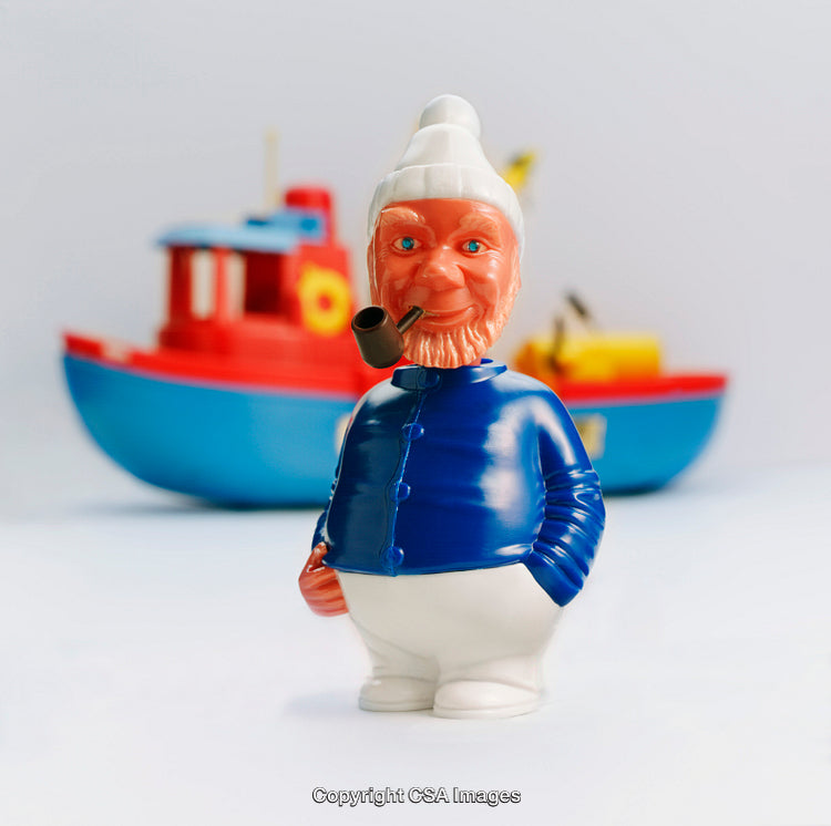 Colorful Plastic Toy Figure of a Sailor with a Pipe and Boat