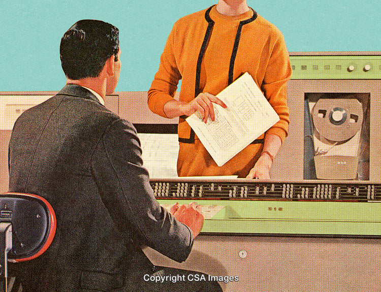 Retro Office Scene Featuring Vintage Computing Equipment and Professionals Collaborating