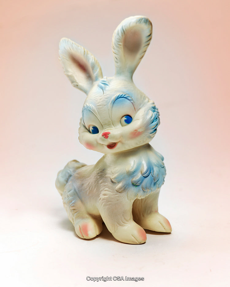 Vintage Toy Bunny Figurine With Colorful Details on Pastel Background