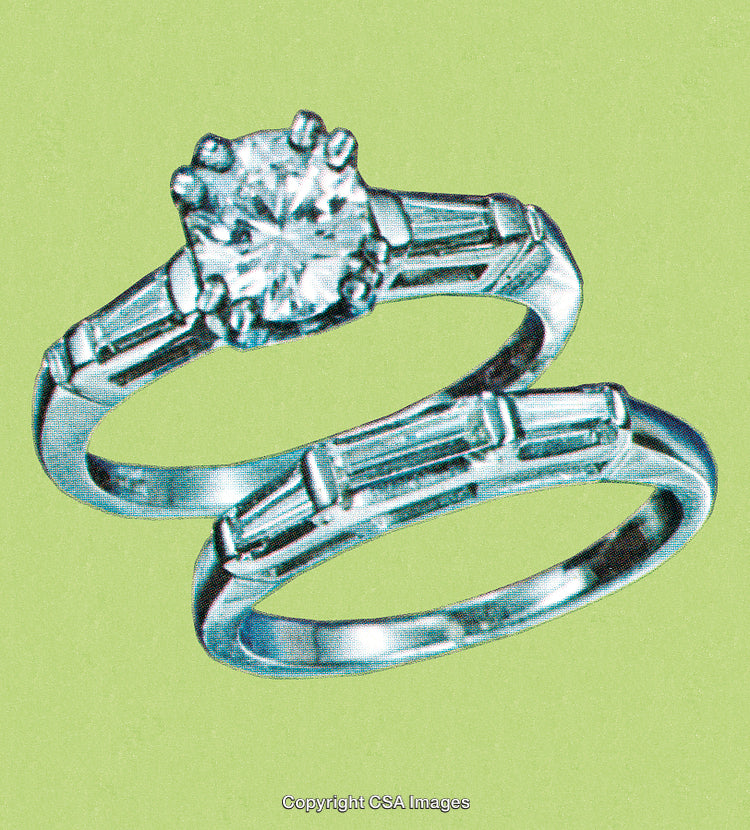 Closeup of Elegant Diamond Engagement and Wedding Rings on Green Background