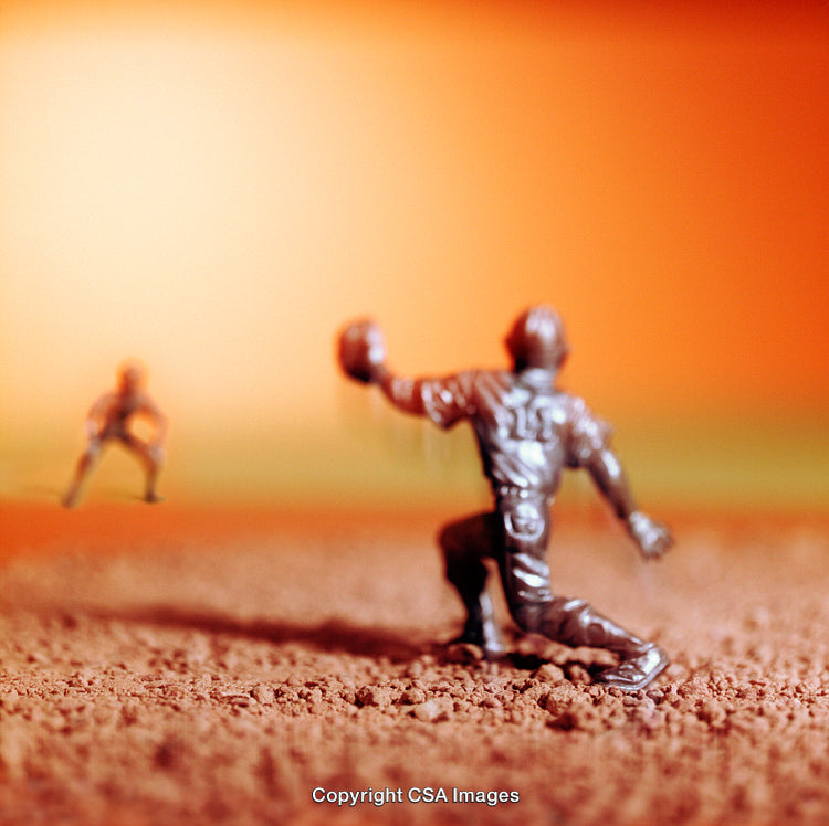 Close-Up of Plastic Baseball Player Figurines on Textured Surface