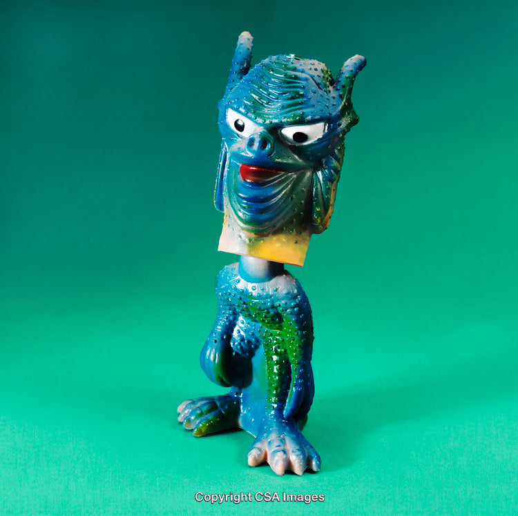 Colorful Monster Toy With Unique Design on Green Background