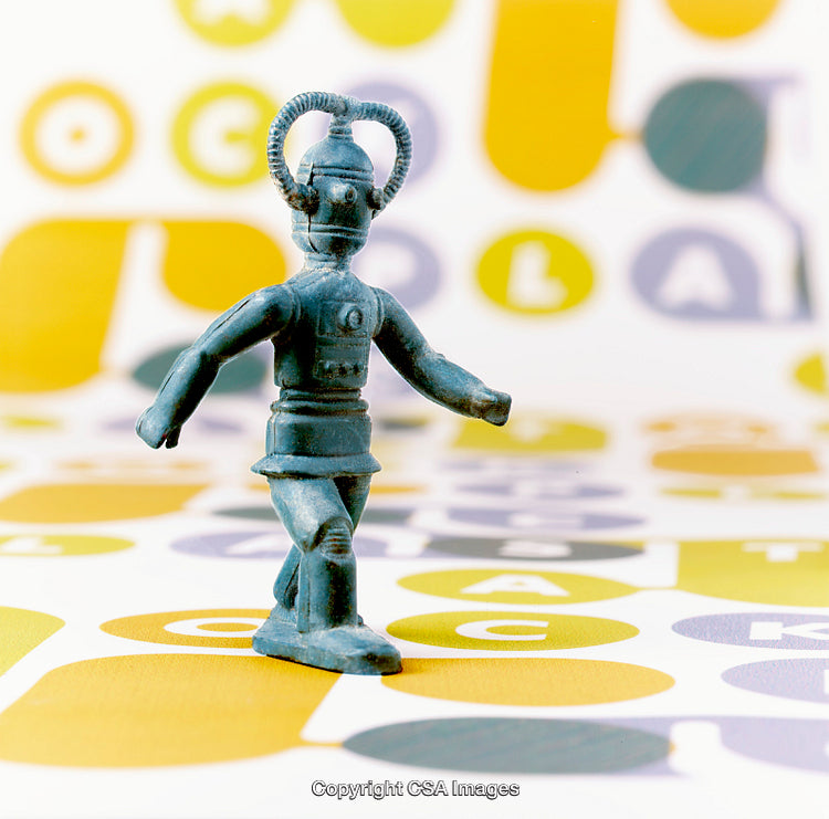 Vintage Plastic Robot Toy Standing on Colorful Geometric Background